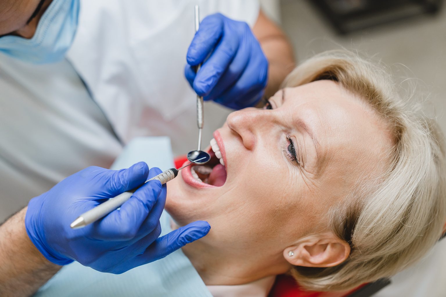 Patient curing caries decay visiting doctor dentist orthodontist at stomatological hospital clinic Closeup female patient curing caries decay visiting doctor dentist orthodontist at stomatological hospital clinic. Teeth tooth whitening
